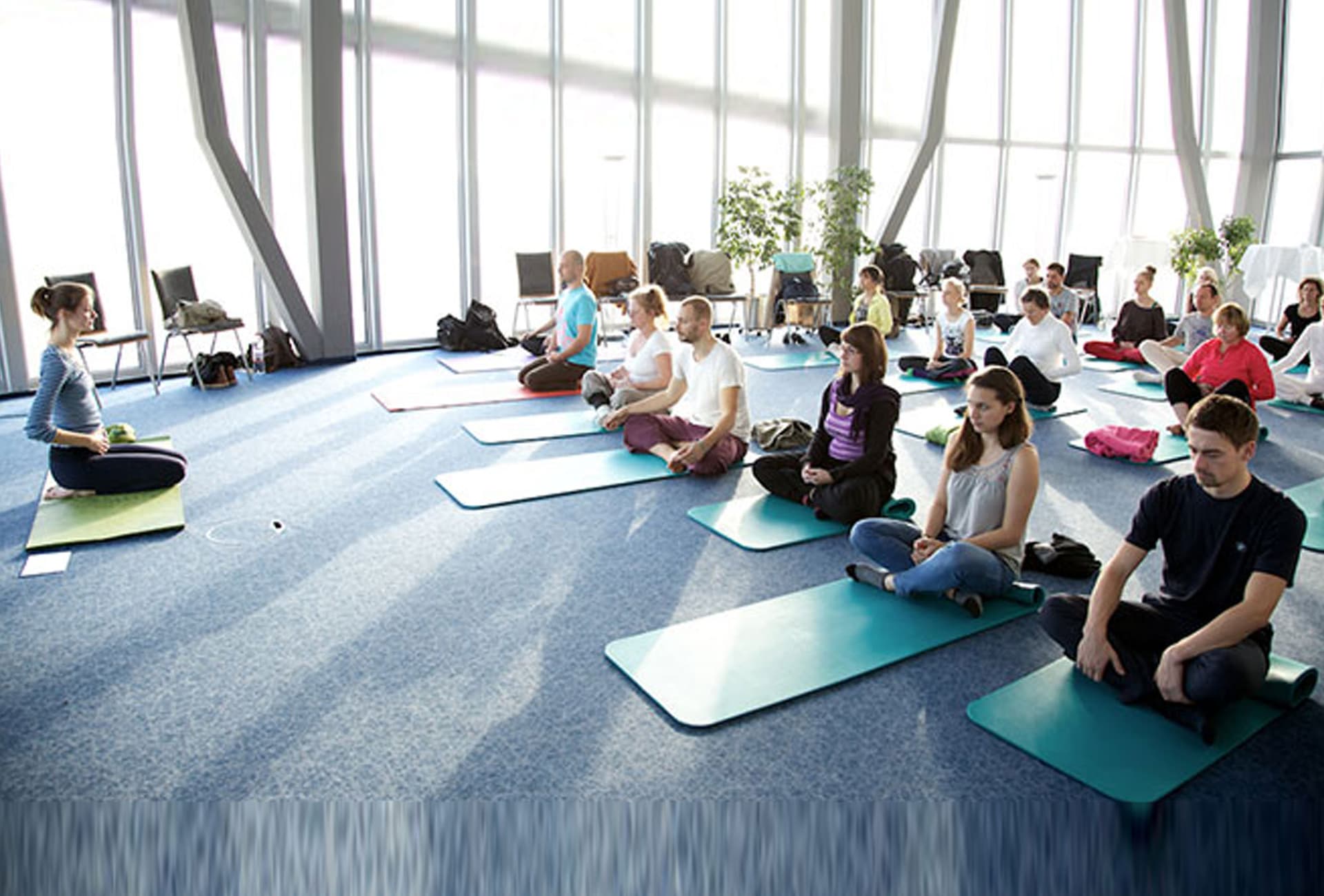 Corporate wellness yoga workshop focusing on desk ergonomics, posture, and stress management